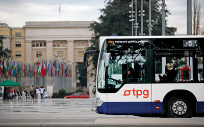 A side view of a bus in front of the United Nations Office at Geneva