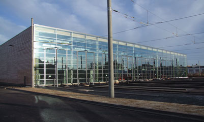The new tram workshop for LVB is clad in wood with glass walls to the front and back