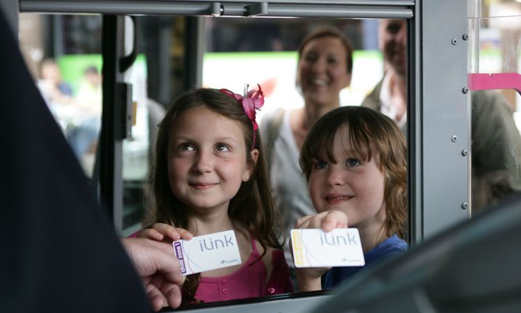 Children using iLink cards on bus
